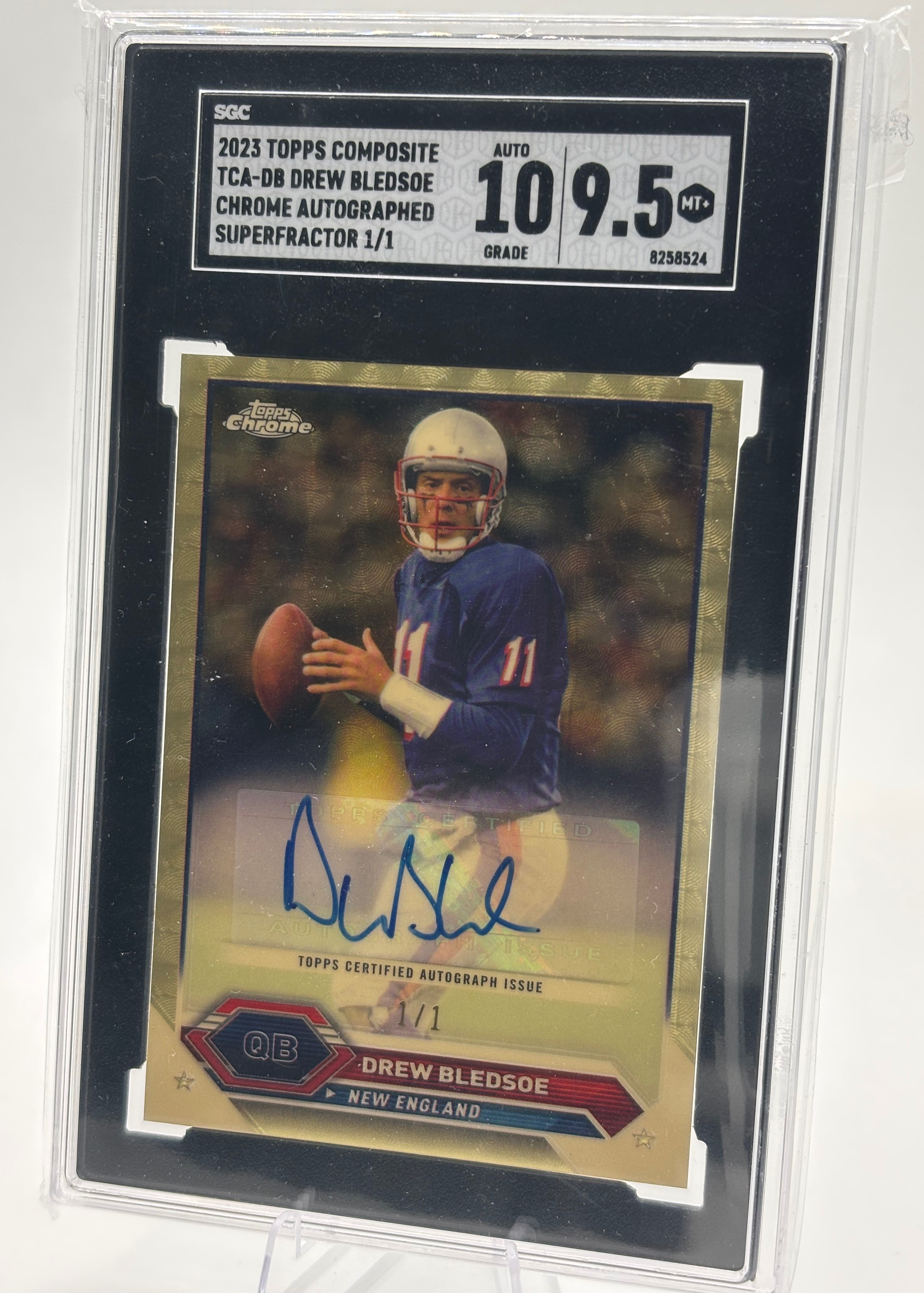 A close-up of a 1/1 Superfractor Drew Bledsoe autographed football card, shimmering with a rainbow foil design.